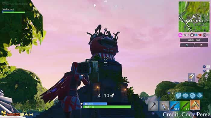 the second of the three locations that we need to find is a crowned tomato again this is an oddly specific and bizarre monument that we need to find - fortnite search between a giant rock man a crowned tomato and a circle tree